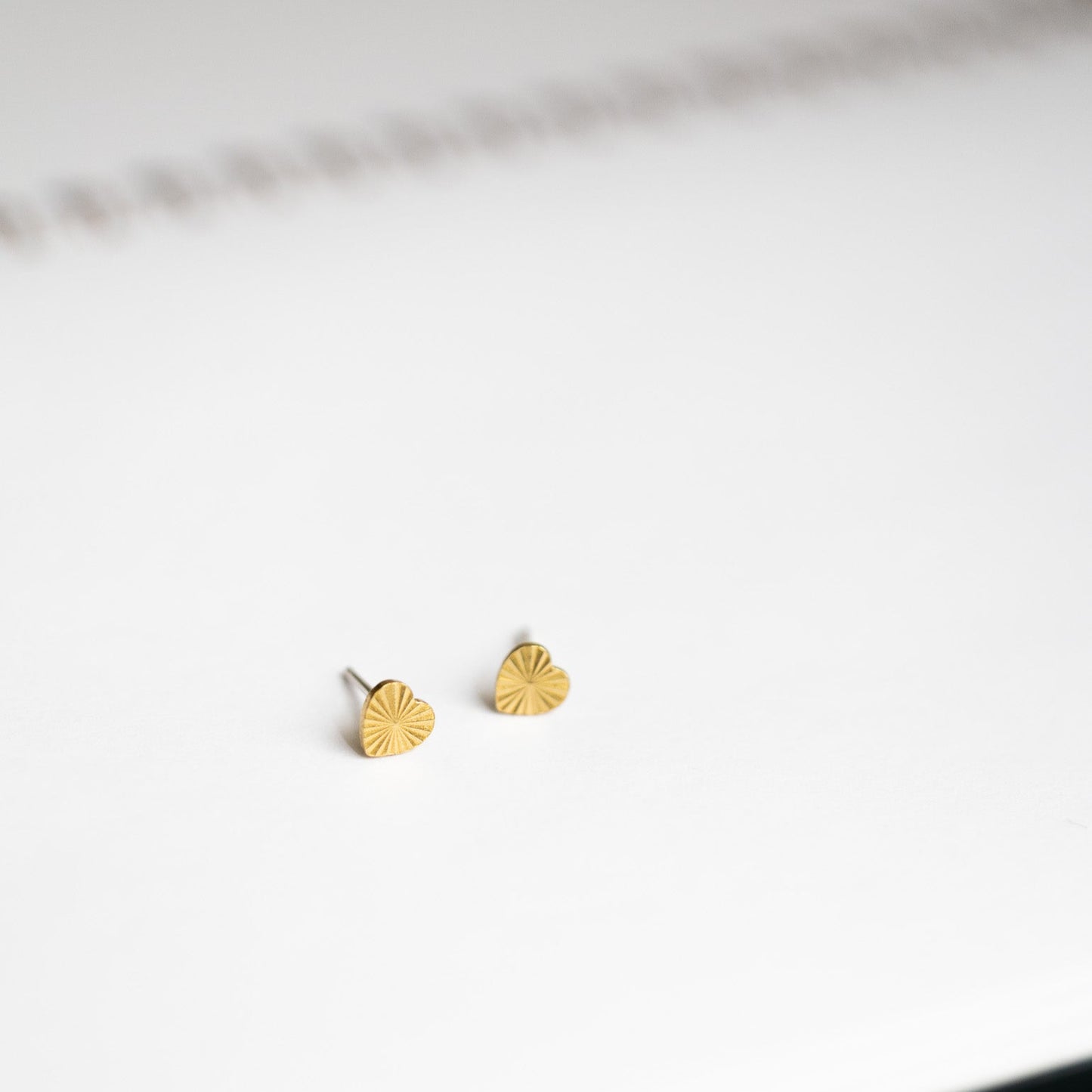 tiny starburst heart studs laying on notebook