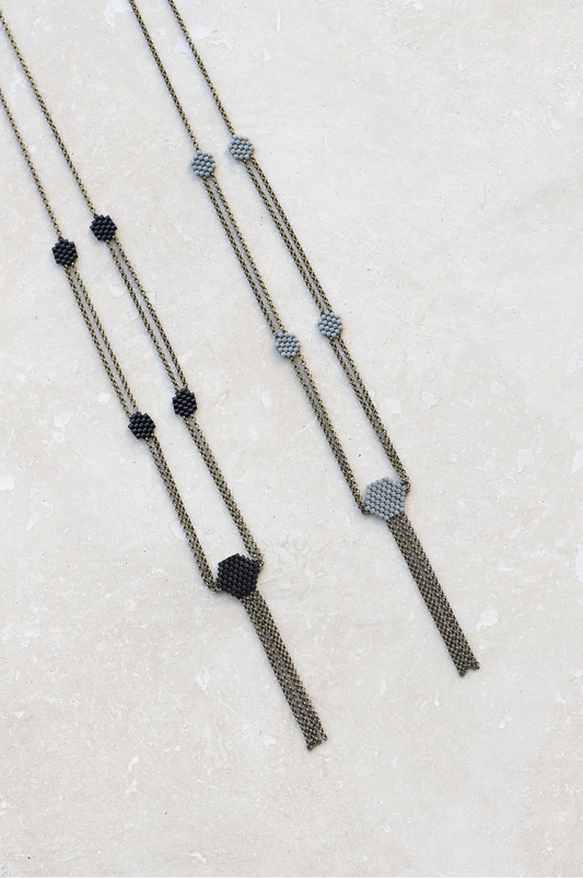 Delicate beaded chain necklaces in black and gray.