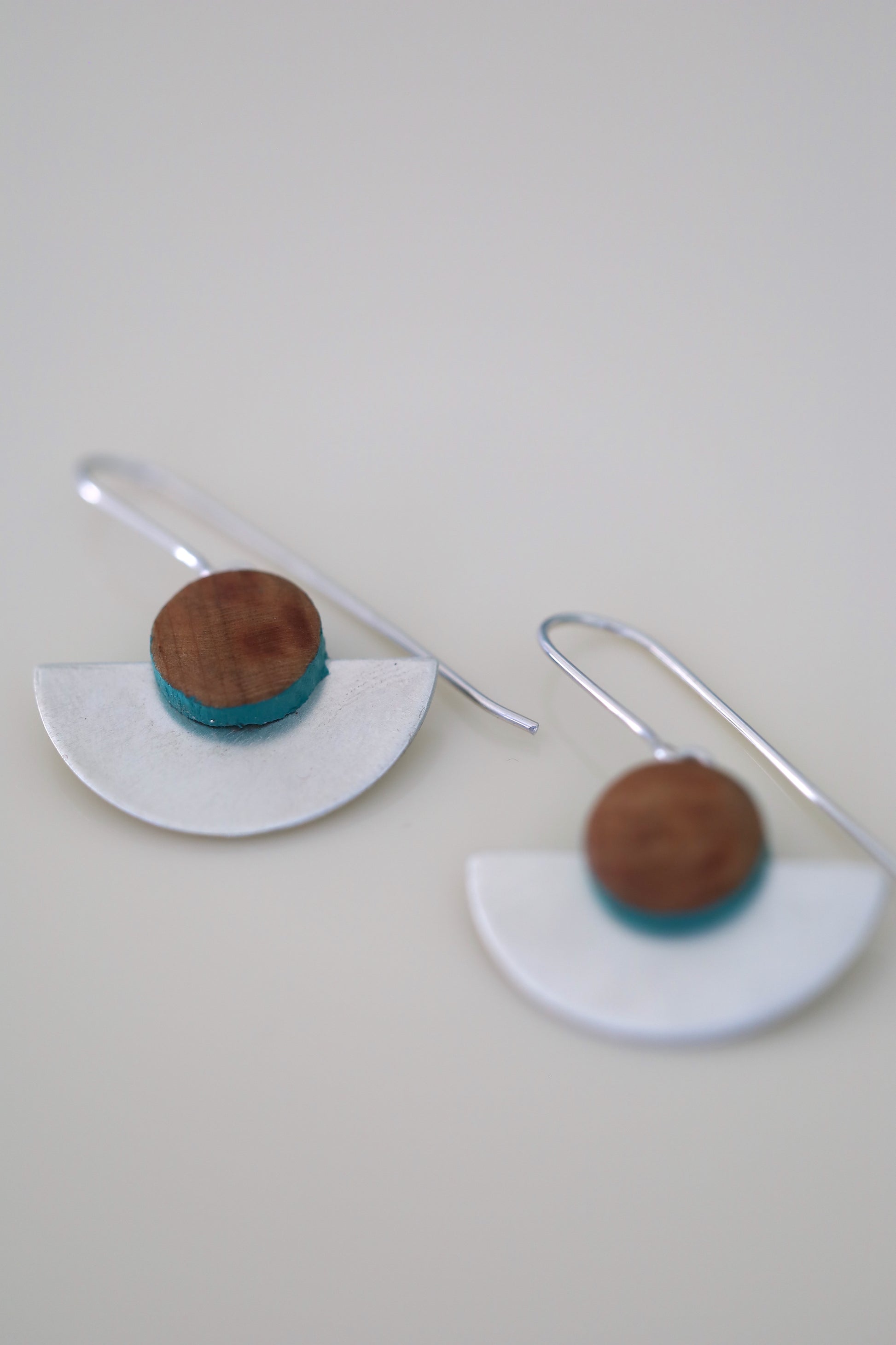 Wood and sterling silver earrings with turquoise painted accents.