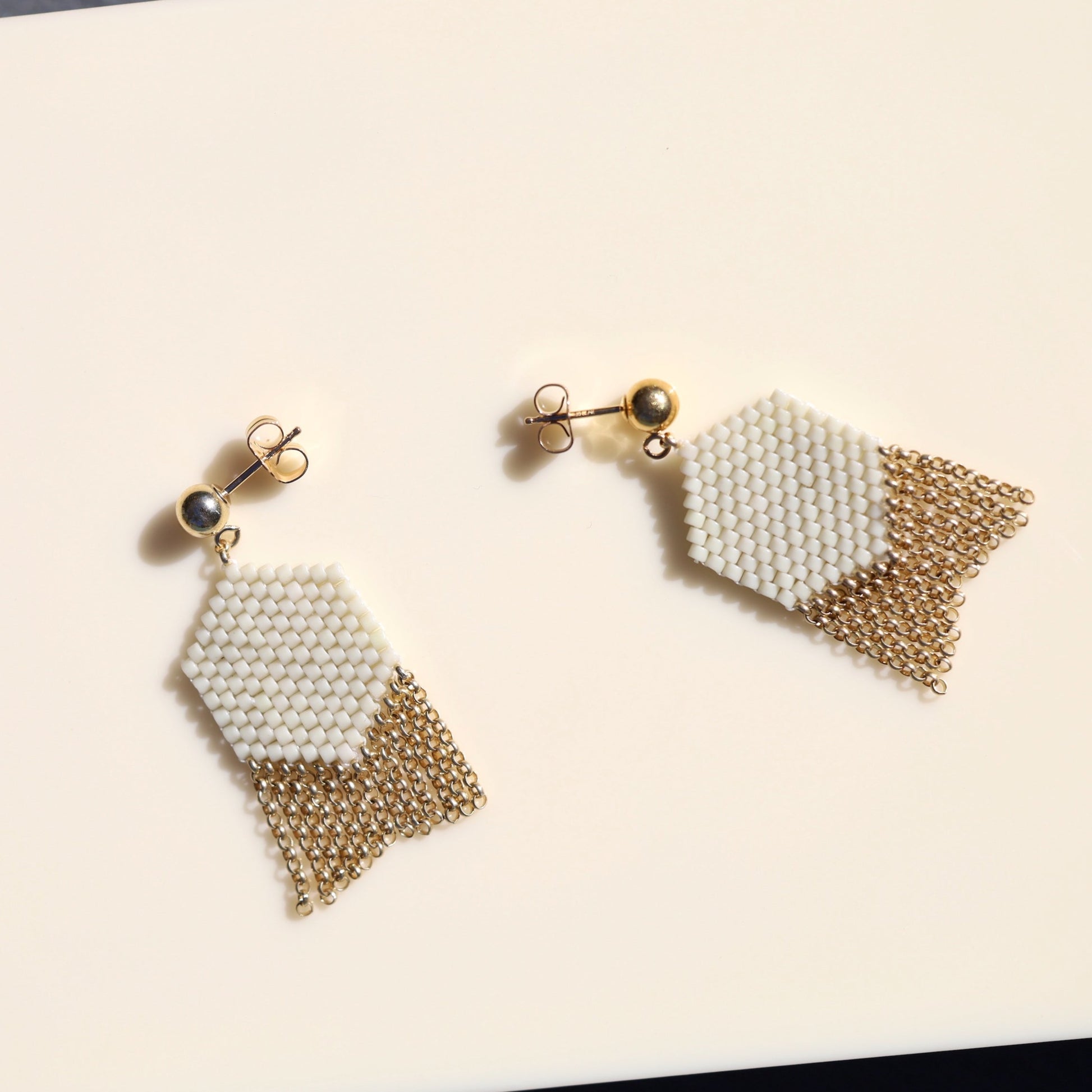 Gold and off-white beaded earrings with 14k gold fill chain.