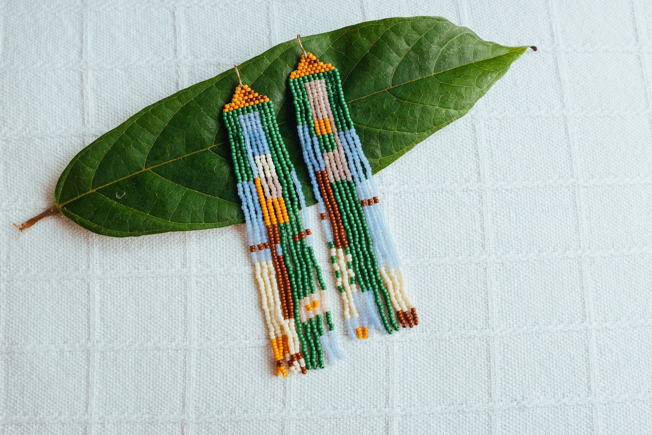 Long colorful beaded earrings in green, gold, blue and red.