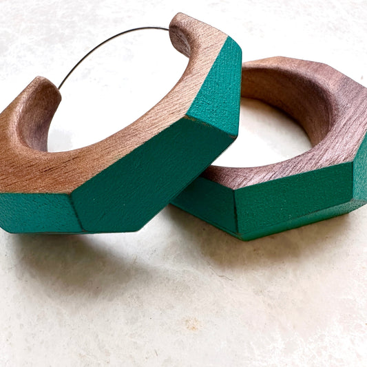 Large statement hoop earrings made from wood with turquoise painted accents.