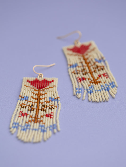 Hand beaded cream colored fringe earrings with red and blue vintage flower motif.