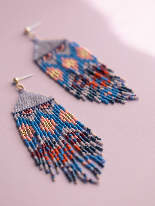 Handwoven beaded stud earrings with blue, pink, gold, red and gray colored beads.