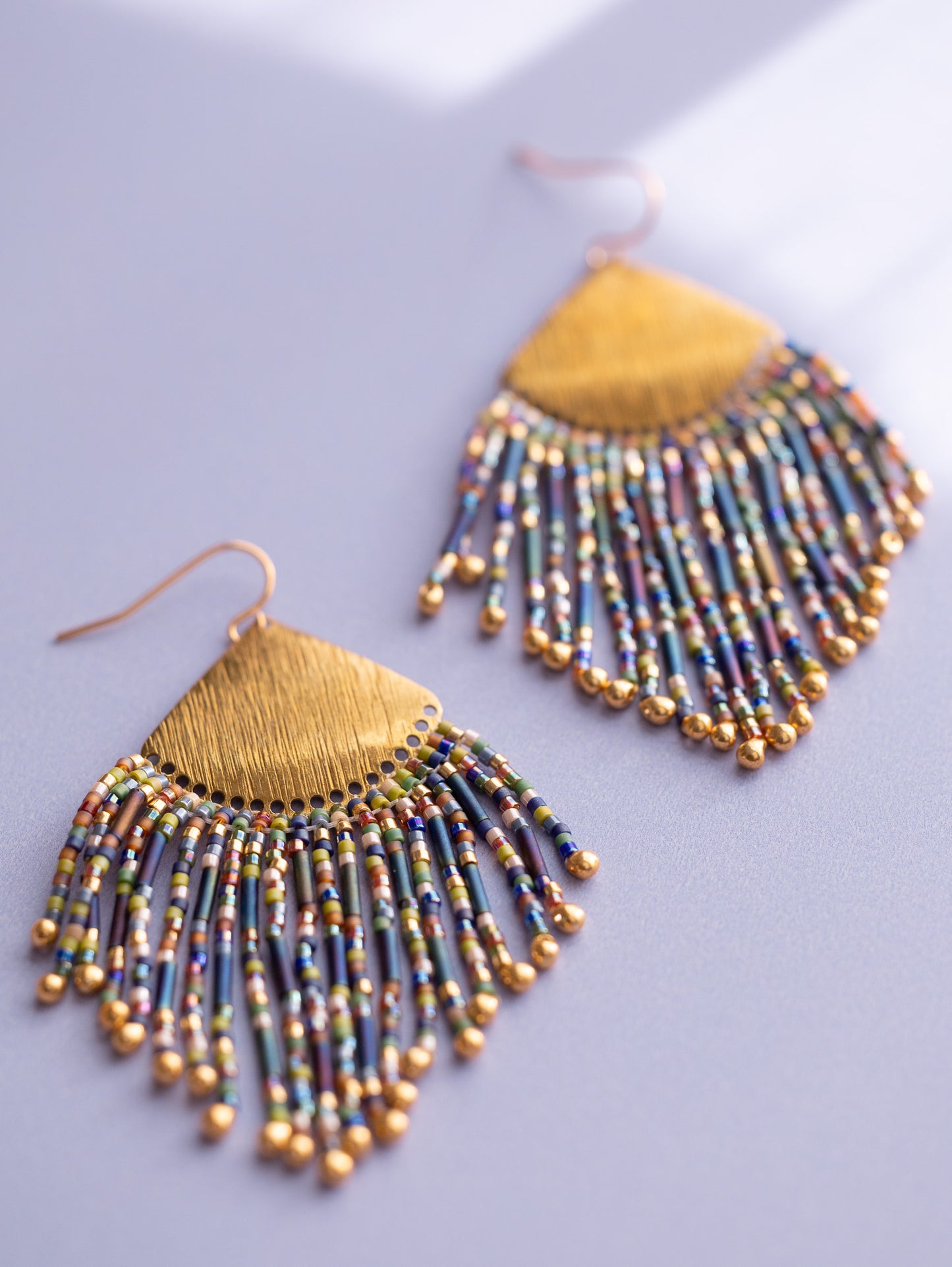 Gold beaded fringe earrings with multi colored beads.