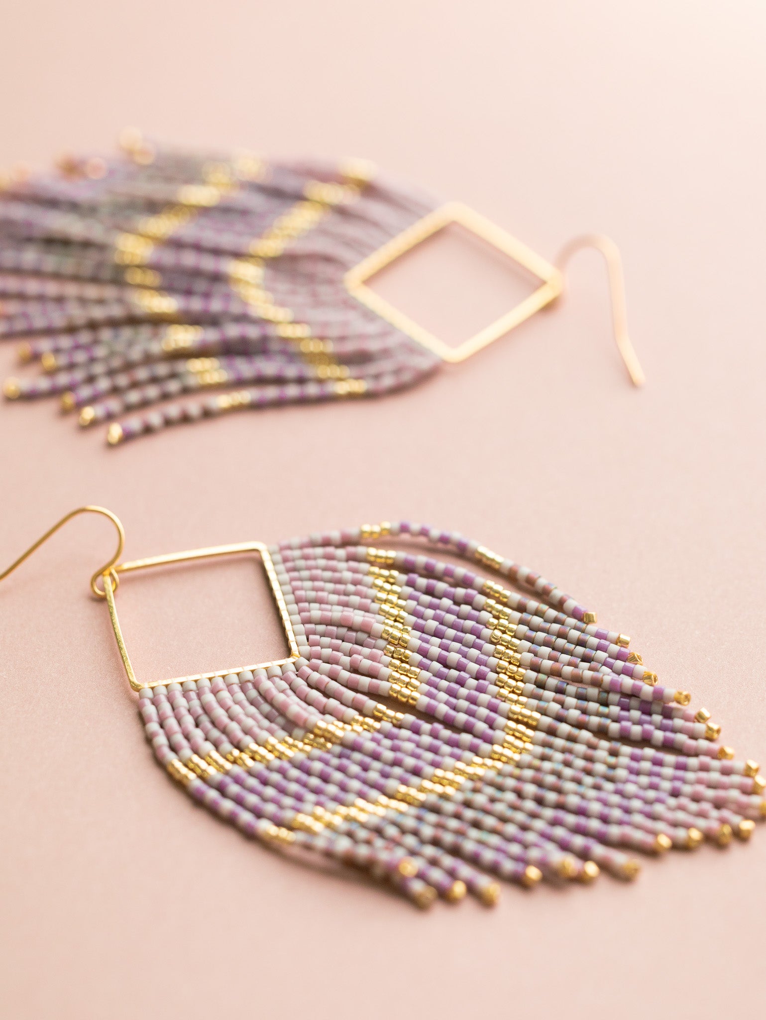 Purple, mauve and gold hand beaded fringe earrings with ombre pattern.