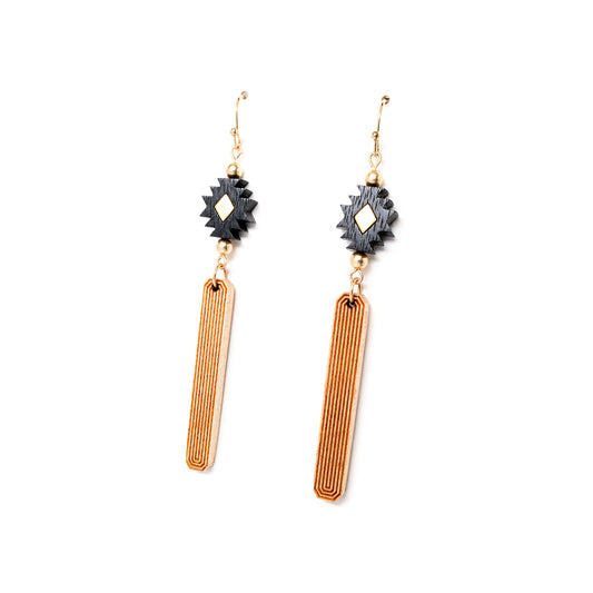 Black, gold and natural wood colored earrings made from laser carved wood from an angle.