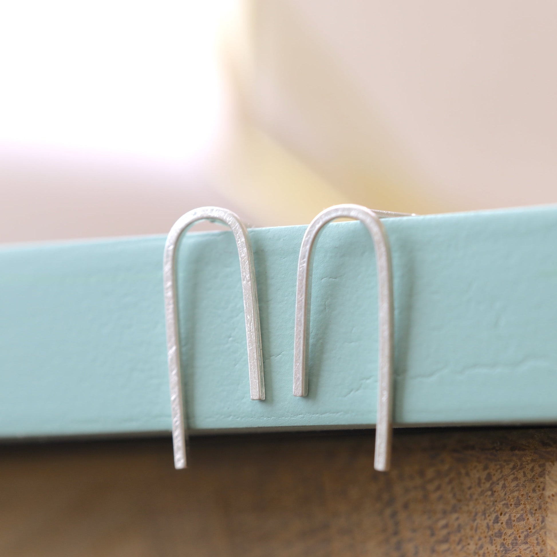 Sterling silver arch earrings close up