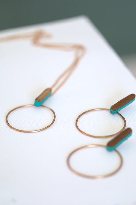Necklace and earring set.  Made of wood with turquoise accents and bronze hoops.