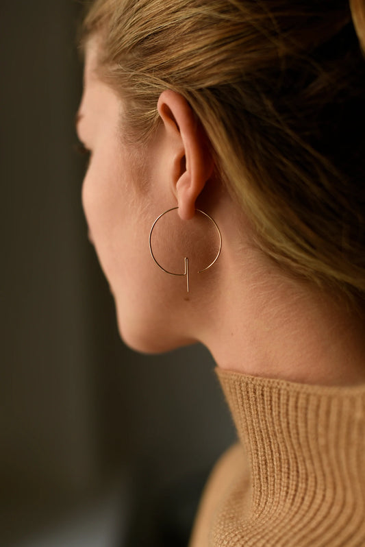 Woman wearing modern hoop threader earrings, back view.