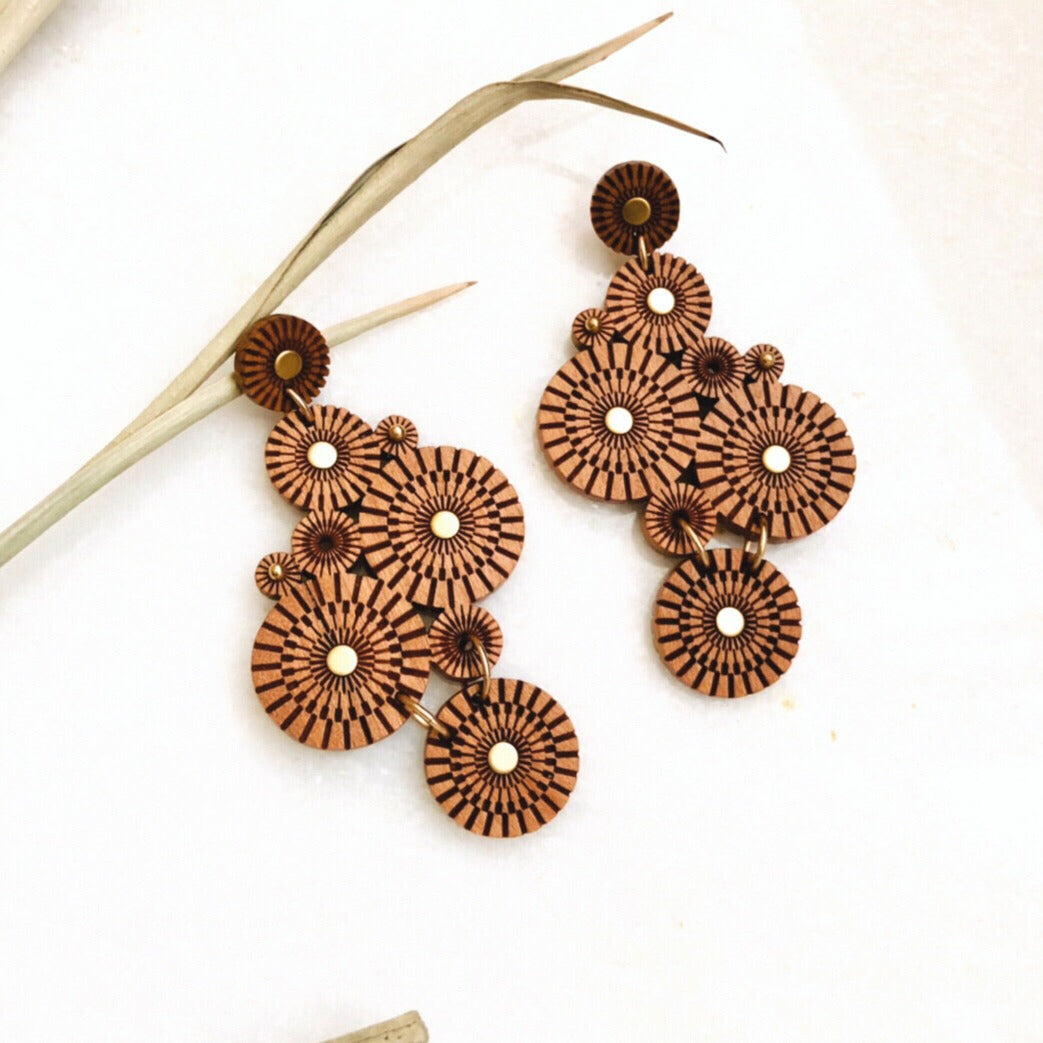 Statement earrings made of various size laser carved circles, with brass accents.