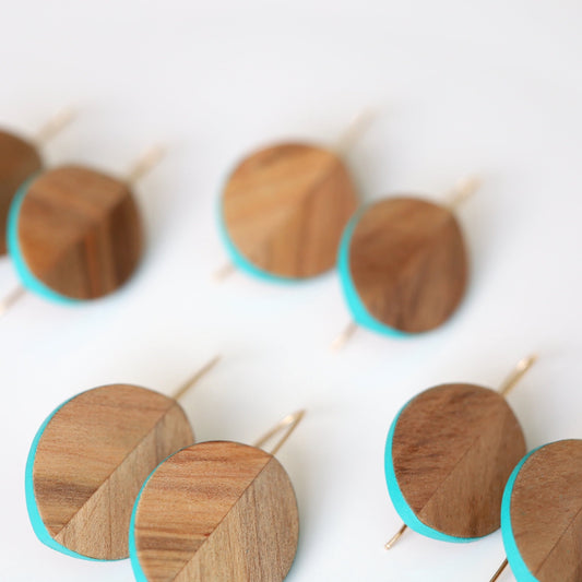 Leaf shaped wood carved earrings with turquoise accents.