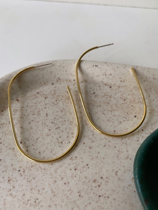 Large oblong gold hoops made from brass.