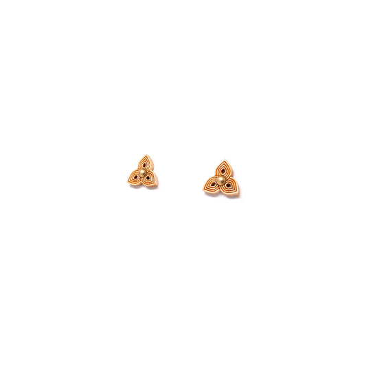 Small stud earrings with leaflet shape made from laser carved light colored wood, angled view.