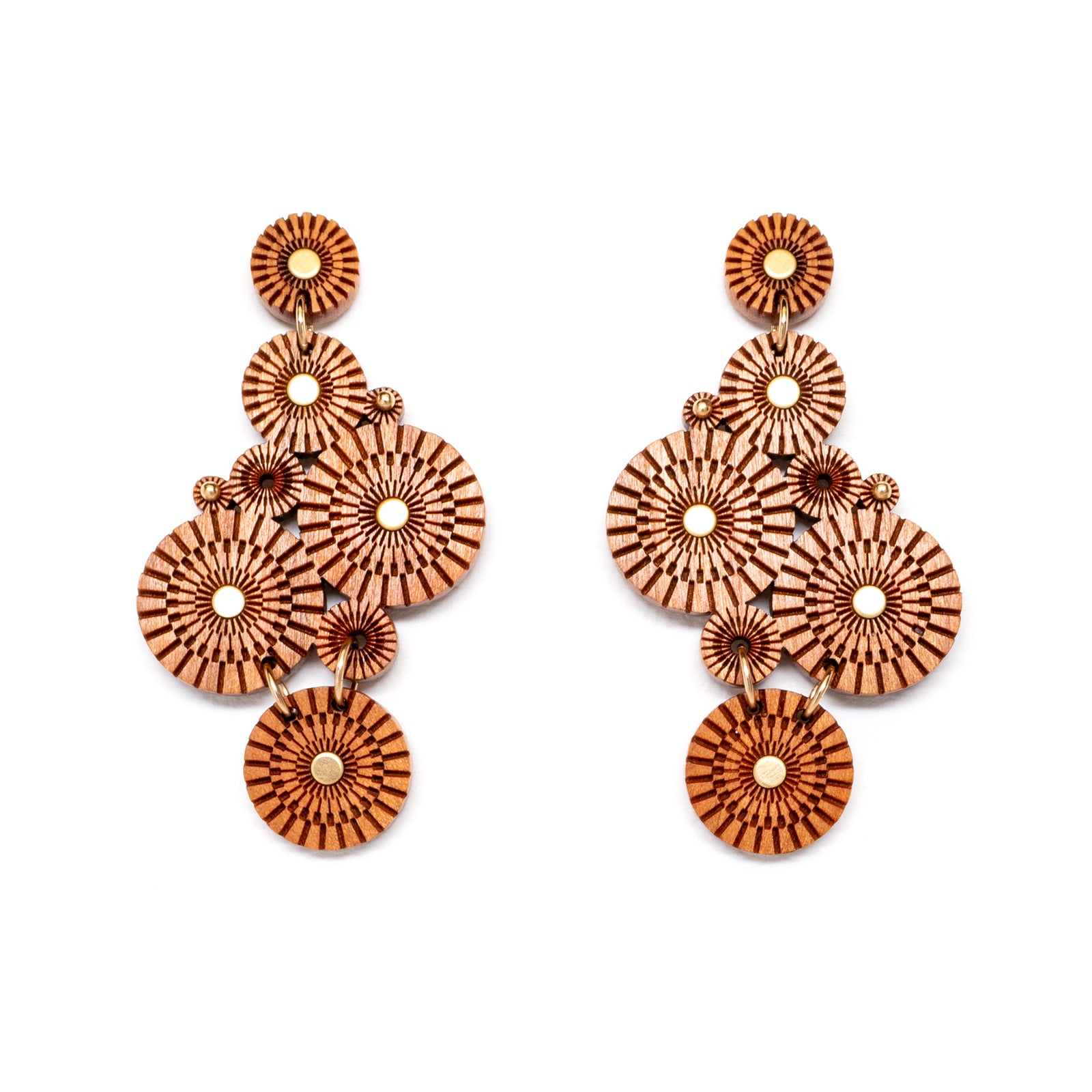 Statement earrings made of various size laser carved circles, with brass accents, flat view.