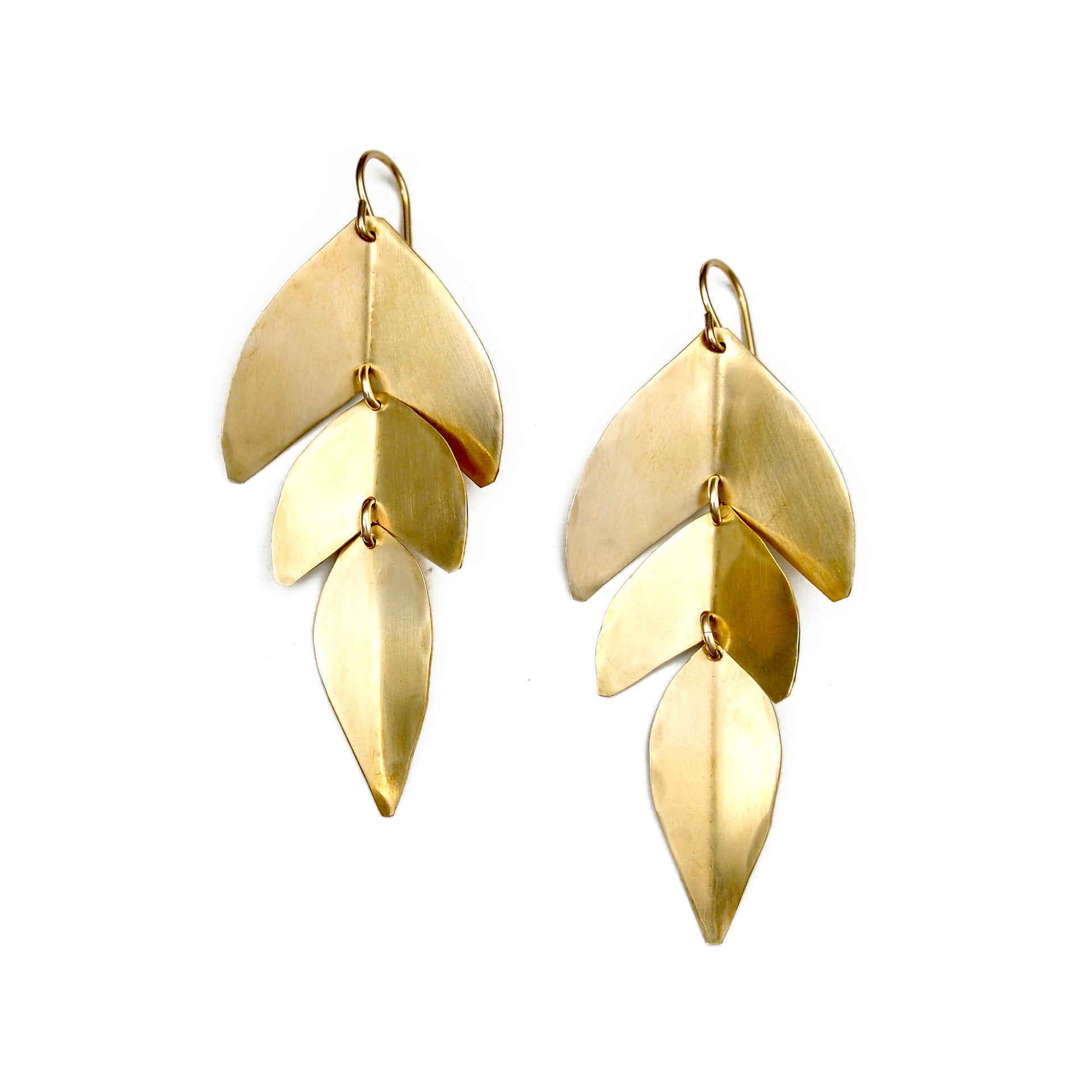 Gold leaf shaped dangle earrings made from hammered metal.